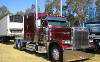 Red Peterbilt 379 with a refrigerated trailer parked outdoors