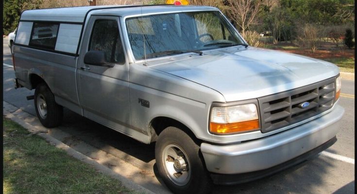 Gray 1992–1996 Ford F-150 pickup parked beside a road