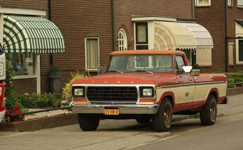 Red and cream 1978 Ford F-150 pickup parked on a residential street