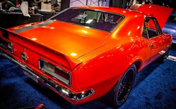 Bright orange 1969 Chevrolet Camaro displayed indoors