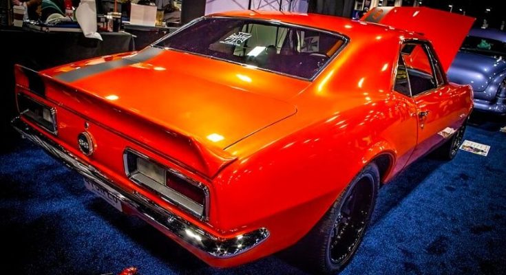 Bright orange 1969 Chevrolet Camaro displayed indoors